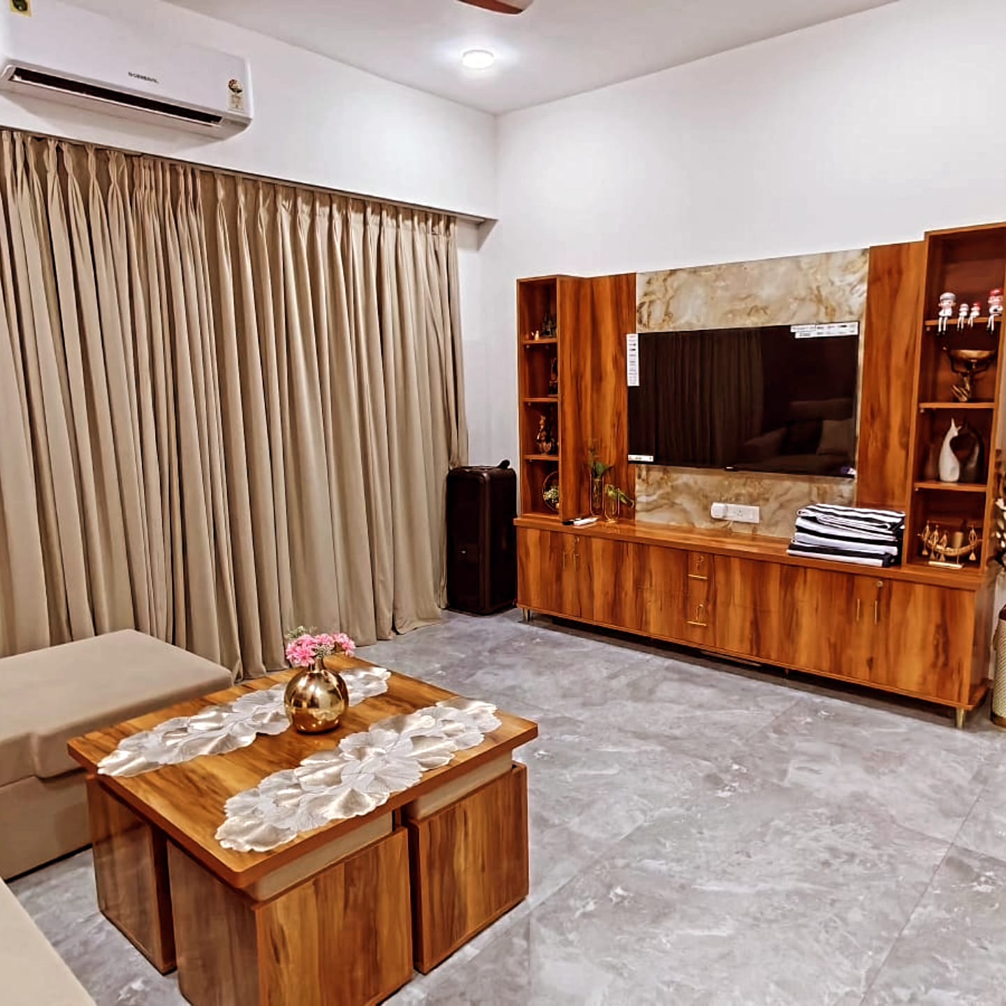 Lounge with wooden TV console and marble backdrop