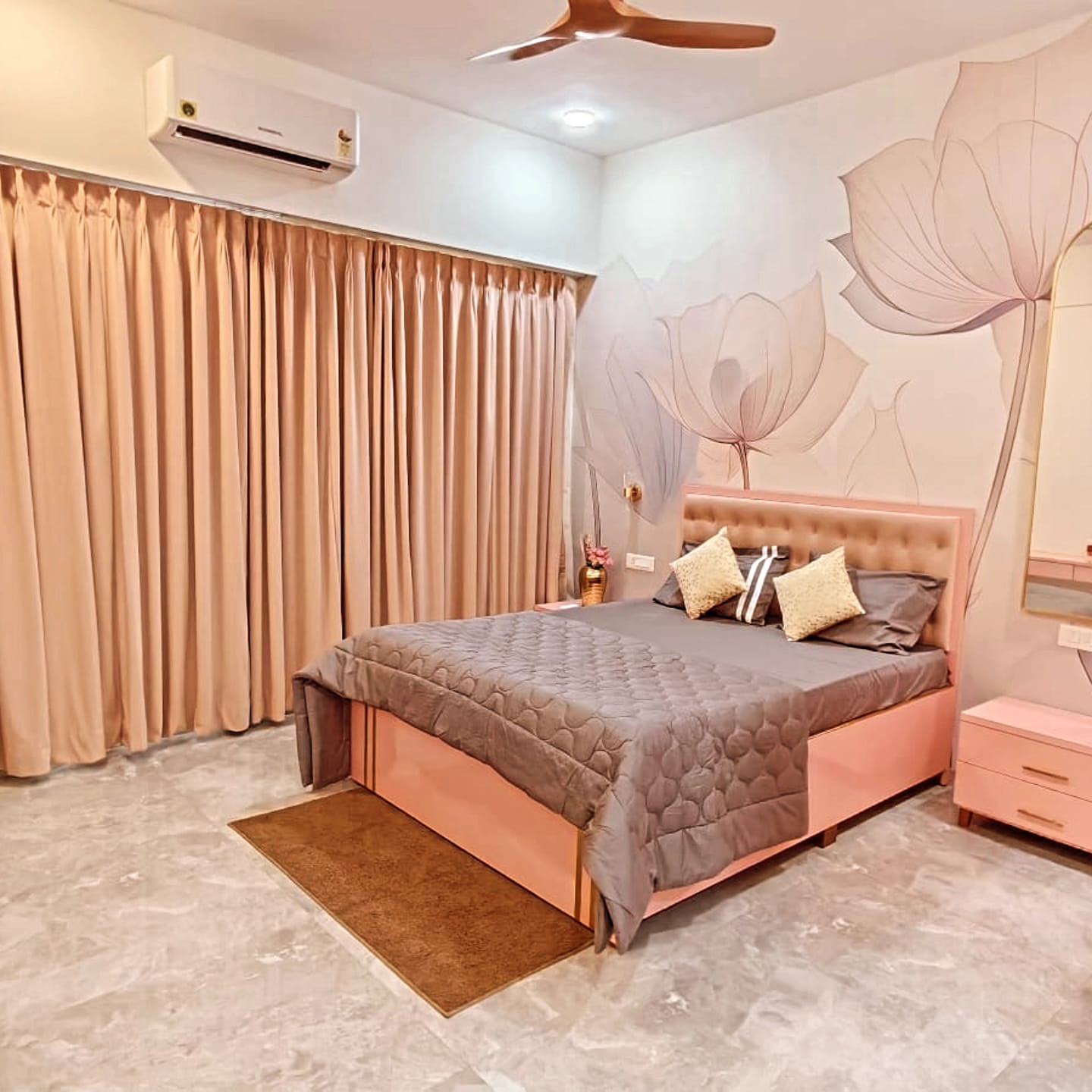 Rose-gold bedroom with tufted headboard and lotus mural
