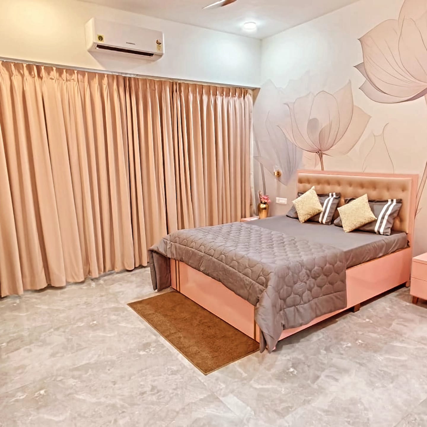 Spacious rose bedroom with full-length curtains